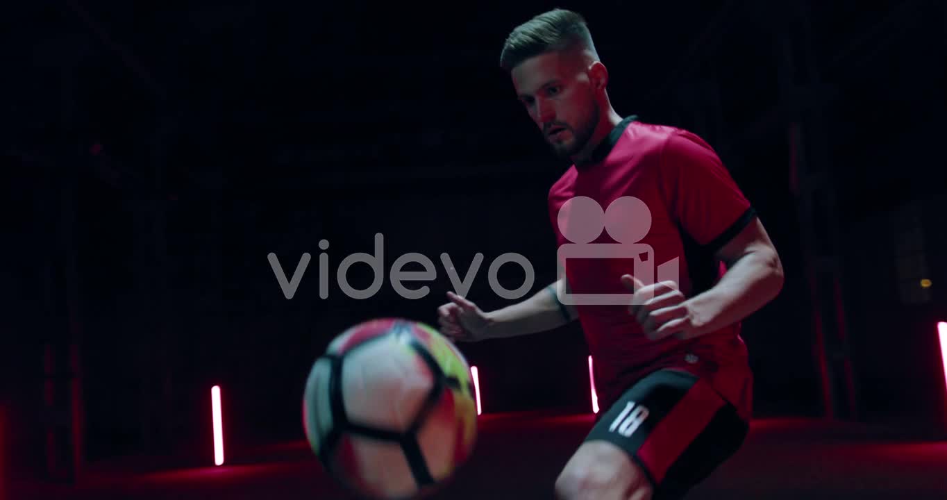 Soccer Player Kicking Up Ball