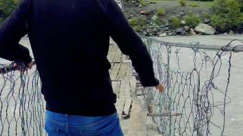 Crossing suspension bridge in hunza pakistan