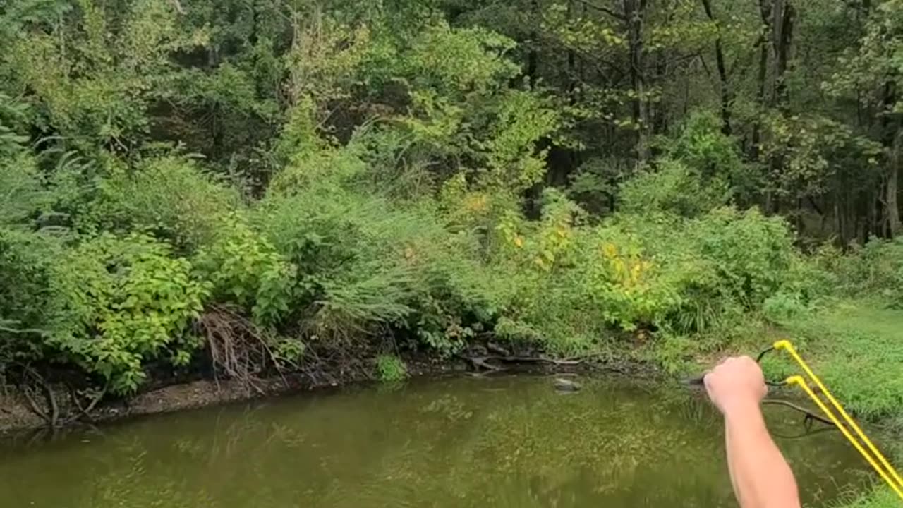 Shooting a balloon with a slingshot in air
