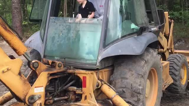 Kid driving a back hoe