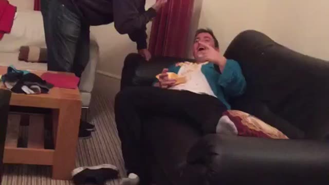 Drunk man on couch fries all over him