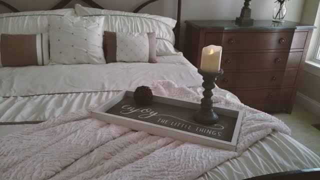 A Ball And Candle Placed Over A Wooden Tray With Inspirational Quote Written