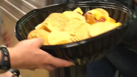 Woman boards train with bike and chips in one hand