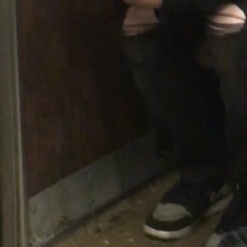 Guy trying to secretly smoke cigarette on subway black hat