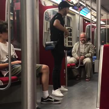 Guy playing accordion subway black clothes white shoes