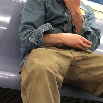 Eyes closed man picks nose on train