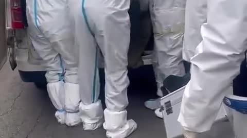 Chinese Covid Police Wrap Citizen in Tape to Arrest Him