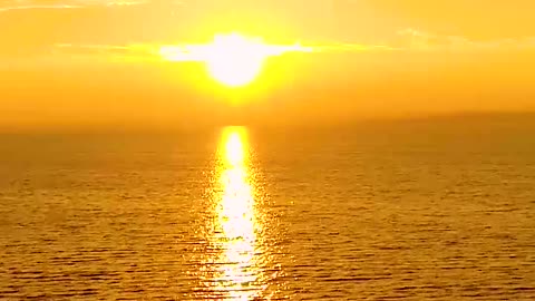 Above the horizon, a serene and brilliant sunset