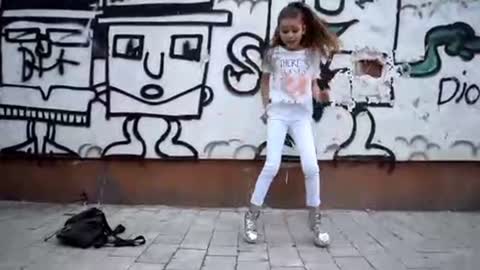 8 years old beautiful girl dance shuffle on street..