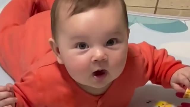 Baby trying to take the first steps of his life.