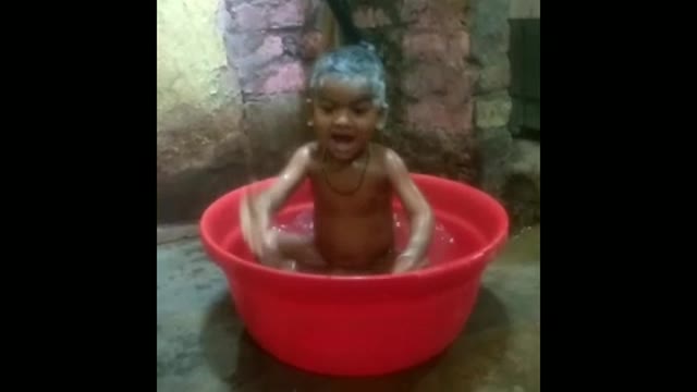 Cute baby in bathtub playing on bath