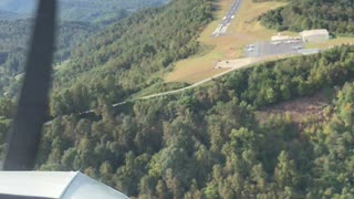 Piper Cherokee landing on a a ridge in the mountains.