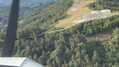 Piper Cherokee landing on a a ridge in the mountains.