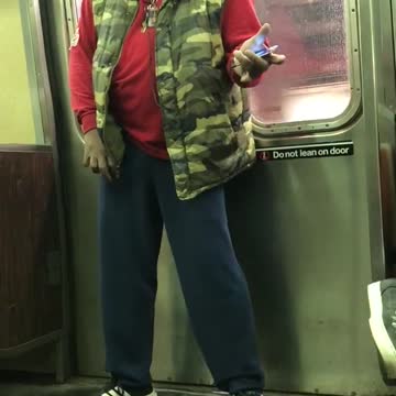 Camo vest red shirt headphones singing jackson 5 song subway