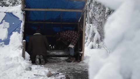 Building the shed's bench in snow. Building a long term camp in snow