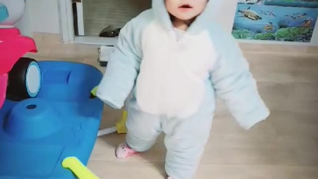 The cuteness of a baby in a blue bear suit