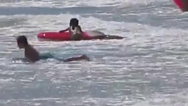 Children swimming at the beach pool - kids playing at the beach - beach game