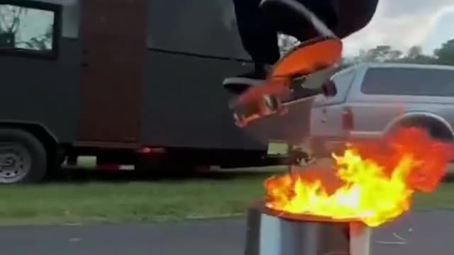 Skateboard leap over brazier