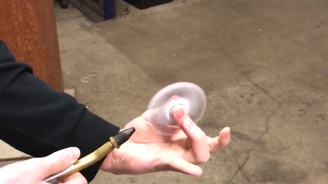 Guy uses air hose on fidget spinner