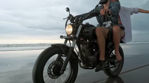 Travelers on a motorcycle by the sea