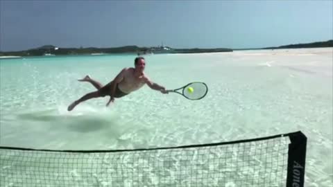 Playing tennis in the ocean? Really good at playing.