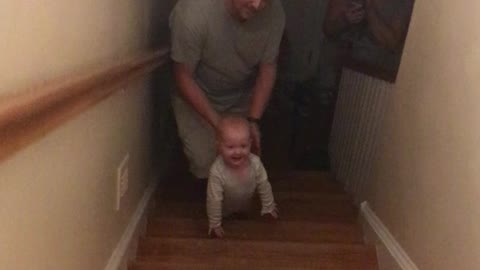 1 year old climbing up the stairs