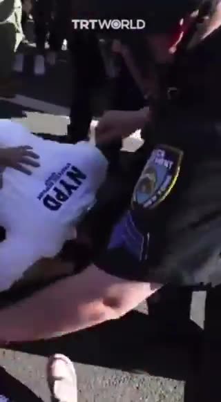 NYPD Captain Knocking Female Protester and Punching Her non-stop.