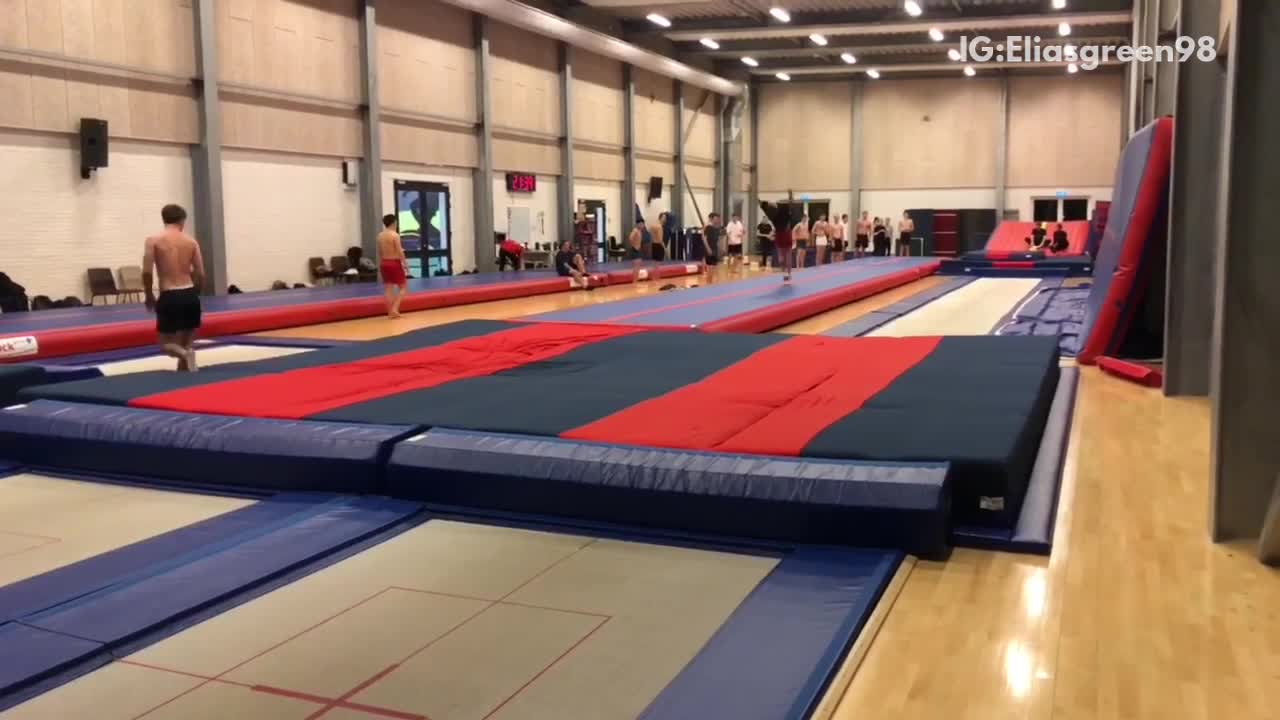 Gymnast does flips, lands on head and shoulder, bounces onto safety pad