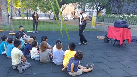 Children watching free performances at the playground