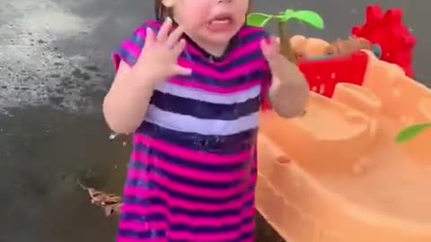 A little girl playing with water