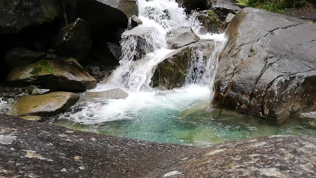 River Water Cascading Through Layers Of Rock