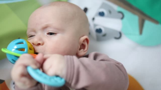 Baby Biting A Toy