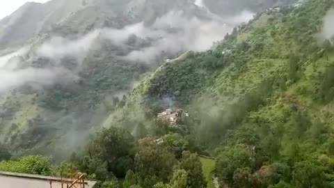 Breathtaking view of clouds sailing on a beautiful valley