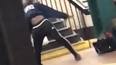 Guy bounces on butt and kicks legs dances in subway