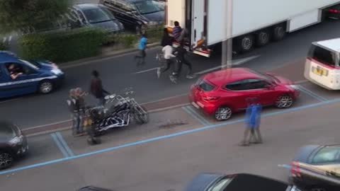 Refugees Run After and Chase Down Truck