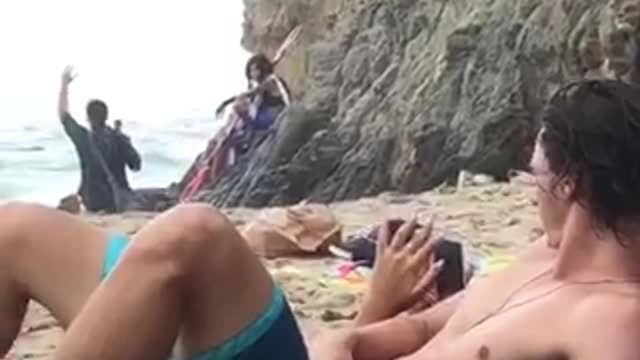 Girl records weird people at beach