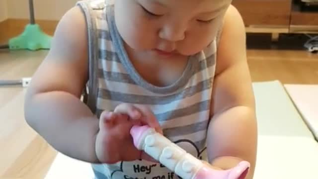 This is a video of a baby playing with toys and having fun.