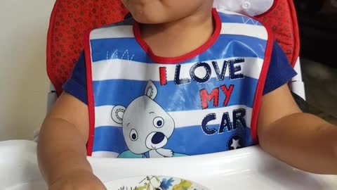 20 months old baby eating with cute face