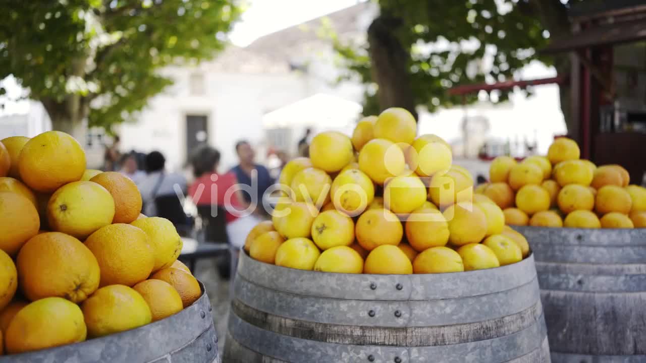 Barrels with oranges near cafe