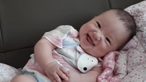 What is the baby laughing at?