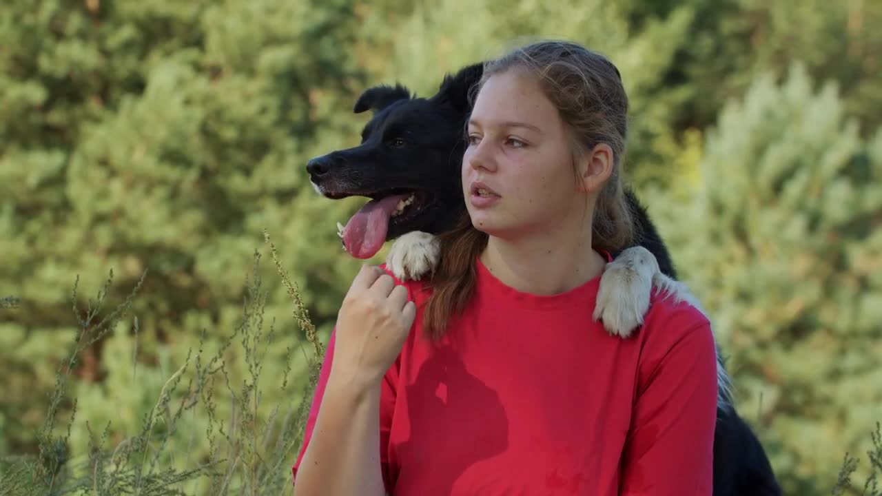 Plump woman and her cute big dog sitting outdoors together