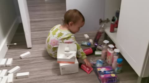 Baby is exploring Mommy's stuff 