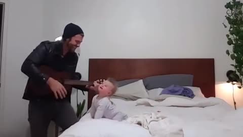 When her dad begins to play the guitar, this baby girl has the best reaction ever!