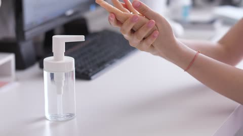 person cleaning their hands with-gel