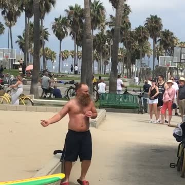 Guy shirtless beach dancing boxing with door