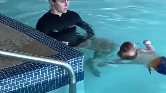 Cute baby swing in swimming pool