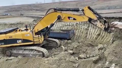 Caterpillar 385 Excavator working on hard