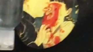 Backpack button with man licking eye