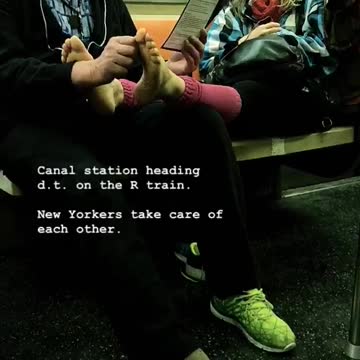 Man massages woman's bare feet on subway car