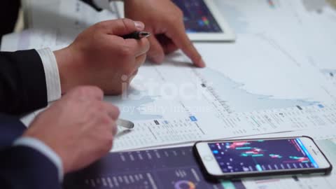 The business finance team analyzes and studies stock market data